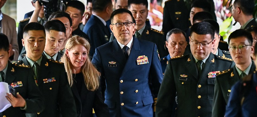 China's defense minister, Dong Jun (C), walks out after a bilateral meeting with U.S. Defense Secretary Lloyd Austin on the sidelines of the 21st Shangri-La Dialogue summit at the Shangri-La Hotel in Singapore on May 31, 2024. 