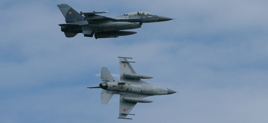 Two F-16 Fighting Falcon fighter jets perform a demonstration during the opening ceremony of the European F-16 Training Center at the 86th Romanian Military Airbase in Fetesti, Romania, on November 13, 2023.