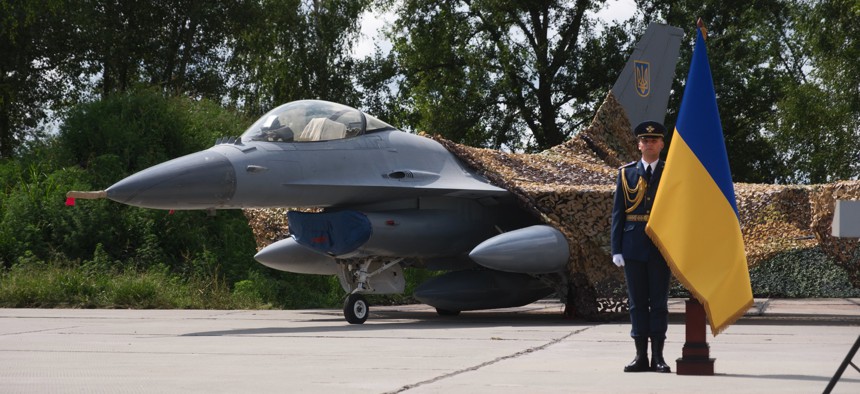 An honor guard member stands in front of the first General Dynamics F-16 Fighting Falcon received by Ukraine, on the Day of Ukrainian Air Force on August 4, 2024.