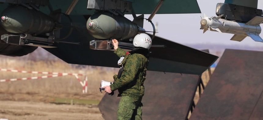 A Russian aviator checks the FAB-500 bombs on a Su-34 bomber before a mission to the Avdiika area on March 8, 2024.