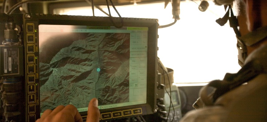 In this 2006 photo, U.S. Army soldiers from the 10th Mountain Division use an electronic GPS map in eastern Afghanistan. 