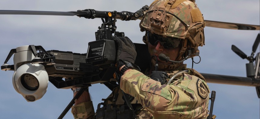 A U.S. soldier carries an Anduril Ghost X.