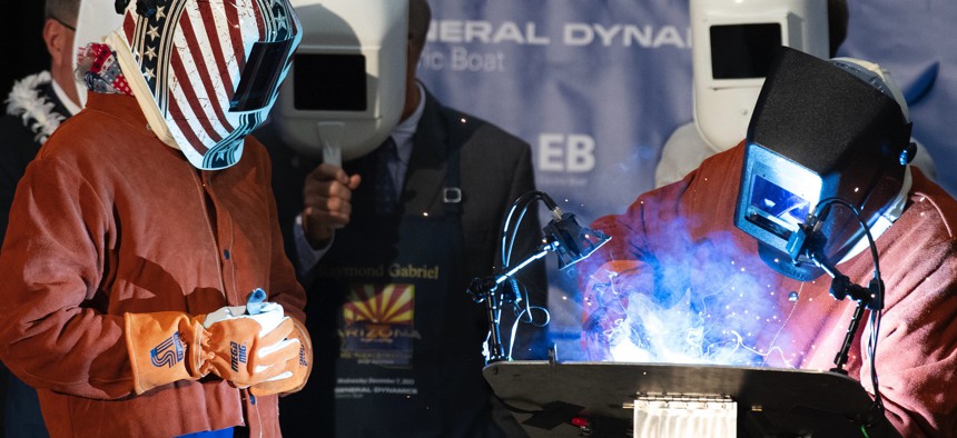 A welder helps weld a steel plate to be mounted on the Virginia-class fast-attack submarine USS Arizona (SSN 803) at General Dynamics Electric Boat's Quonset Point facility in North Kingstown, Rhode Island. 