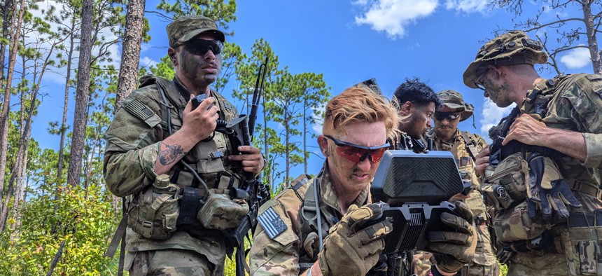 Staff Sgt. David Meyer controls a drone amid other members of the 101st Airborne's new Lethal Unmanned Systems platoon at Fort Johnson, Louisiana. 