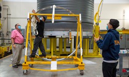 In this 2021 photo, Aerojet Rocketdyne employees prepare a manifold for the furnace as part of the process of manufacturing engines for NASAs Space Launch System rocket.