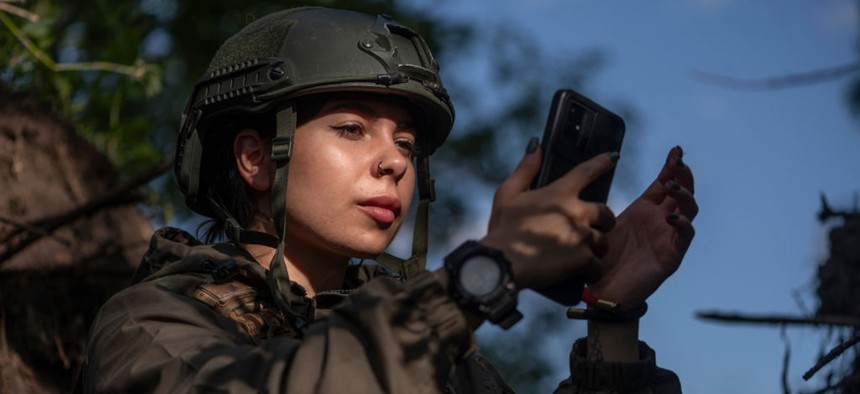 Kateryna Petrenko, press officer of Ukraine's 148th Artillery Brigade, takes video on May 6, 2024, in Donetsk Oblast, Ukraine.