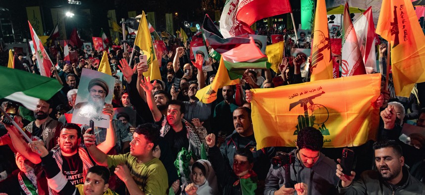 Demonstrators celebrate during a rally in Tehran on October 1, 2024, after Iran fired a barrage of missiles into Israel in response to the killing of Hezbollah leader Hassan Nasrallah and other Iranian-backed militias.