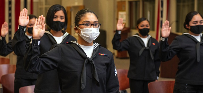 U.S. sailors swear the Oath of Allegiance, becoming U.S. citizens during their naturalization ceremony at Joint Base San Antonio-Fort Sam Houston, Texas, on Dec. 15, 2021.