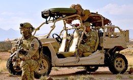 A U.S. soldier with 1st Space Brigade operates a miniaturized satellite data system in a  vehicle guarded by a British Army soldier during a Project Convergence event at White Sands Missile Range on Feb. 28, 2024.