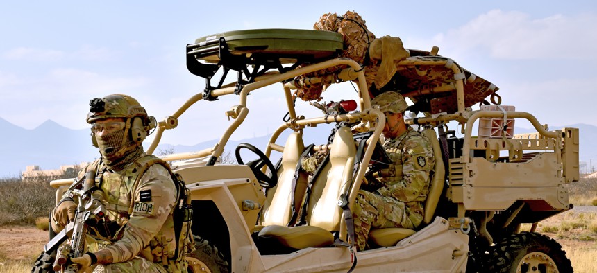 A U.S. soldier with 1st Space Brigade operates a miniaturized satellite data system in a  vehicle guarded by a British Army soldier during a Project Convergence event at White Sands Missile Range on Feb. 28, 2024.