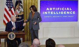 U.S. President Joe Biden hands Vice President Kamala Harris the pen he used to sign an executive order regarding artificial intelligence, Oct. 30, 2023. 