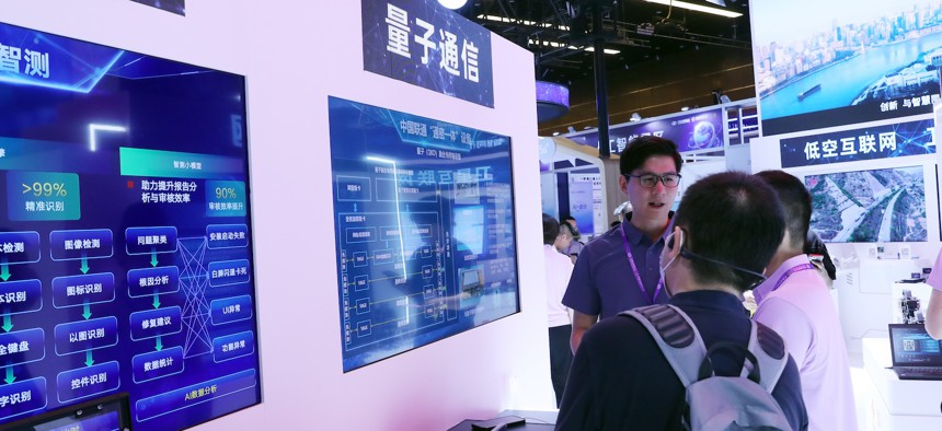 Participants learn about quantum communication at the exhibition area of the 2024 China Internet Conference in Beijing.