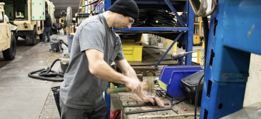 In this 2021 photo, a Rock Island Arsenal - Joint Manufacturing and Technology Center employee works on the assembly line at Rock Island Arsenal, Ill. 