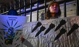 Ukrainians and other protesters gather in the rain outside the Russian Embassy in Warsaw, Poland, displaying flags and messages in solidarity with Ukraine to mark the thousandth day of the Russia-Ukraine war, November 19, 2024.