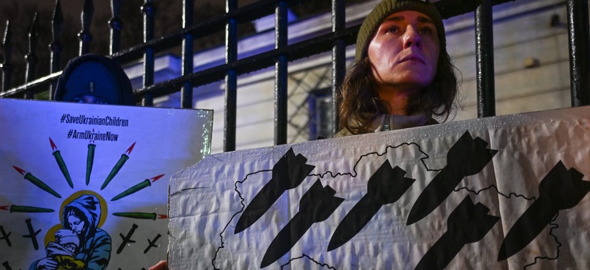 Ukrainians and other protesters gather in the rain outside the Russian Embassy in Warsaw, Poland, displaying flags and messages in solidarity with Ukraine to mark the thousandth day of the Russia-Ukraine war, November 19, 2024.