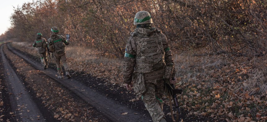 Ukrainian soldiers walk towards their fighting position, in the direction of Toretsk in Donetsk Oblast, Ukraine, on November 17, 2024. 