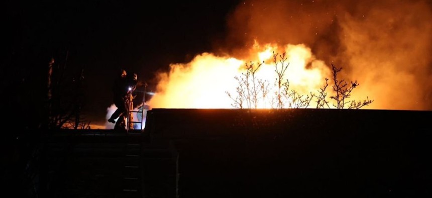 Firefighters work at the site of a Russian missile strike in Dnipro, Ukraine, November 21, 2024.