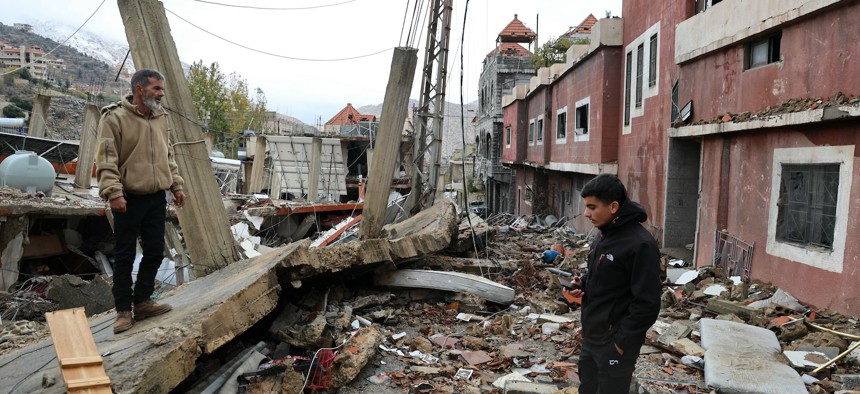 Residents who had fled the southern Lebanese border village of Shebaa check the damage upon their return following a ceasefire between Israel and Hezbollah took effect on November 27, 2024.