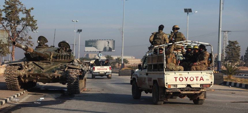 Anti-regime fighters patrol in Aleppo on December 2, 2024. Over the weekend, the Islamist Hayat Tahrir al-Sham (HTS) group and allied factions took most of the northern Syrian city. 