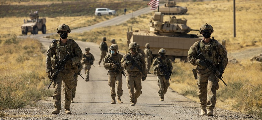 Soldiers with the U.S. Army's 1st Armored Division make their way to an oil production facility in Syria to meet with its management team on Oct. 27, 2020.