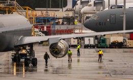 Workers stand near KC-46A Pegasus aerial refueling jets at Boeing's airplane production facility in Everett, Washington, in 2021. 