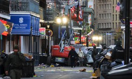 Police investigators surround the white Ford F-150 pickup truck that crashed into a work lift after allegedly driving into a crowd of New Year's revelers in the French Quarter of New Orleans, Louisiana, on January 1, 2025. 