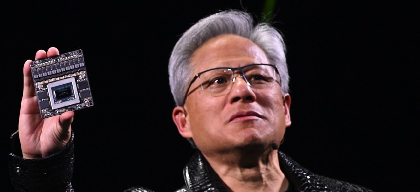 Nvidia CEO Jensen Huang shows off a new chip during his keynote presentation at CES 2025 in Las Vegas, Nevada, on January 6, 2025.