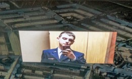 Photo illustration of Jack Teixeira reflected in an image of the Pentagon.