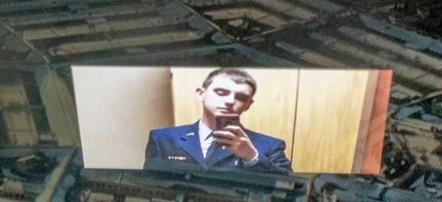 Photo illustration of Jack Teixeira reflected in an image of the Pentagon.