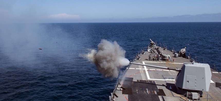 The Arleigh-Burke class guided-missile destroyer USS Sampson (DDG 102) fires its Mark 45 5-inch gun during a live-fire exercise in 2017.