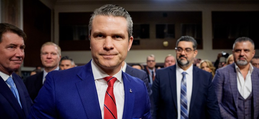 Pete Hegseth (C), accompanied by Sen. Bill Hagerty (R-TN) (L) greets supporters as he arrives for a Senate Armed Services confirmation hearing on Capitol Hill on January 14, 2025, in Washington, DC. 