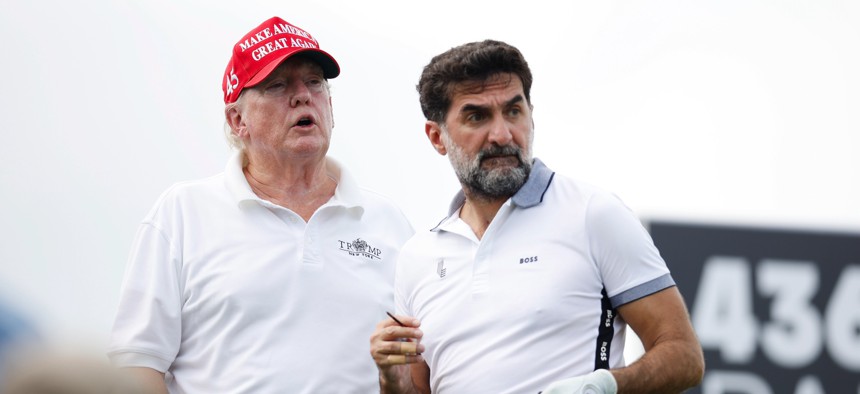 Golf tournaments are just one way foreign governments can line the new president's pockets. This 2022 photo shows Donald Trump and Yasir al-Rumayyan, head of the Saudi sovereign wealth fund, at a LIV Golf tournament at Trump's New Jersey golf course.