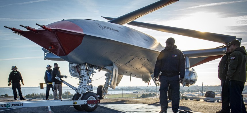 Sailors and Boeing employees test the Boeing unmanned MQ-25 aircraft on the flight deck aboard the aircraft carrier USS George H.W. Bush in 2021.