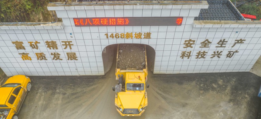 Workers load mined phosphate rocks into trucks at the plant of the Ferriichong phosphate mine in Bijie, China, on December 4, 2024.