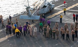 Sailors and Marines aboard the amphibious assault ship USS Bataan (LHD 5) do a FOD walkdown as the ship sails through the Strait of Bab-Al-Mandeb in June 2020.