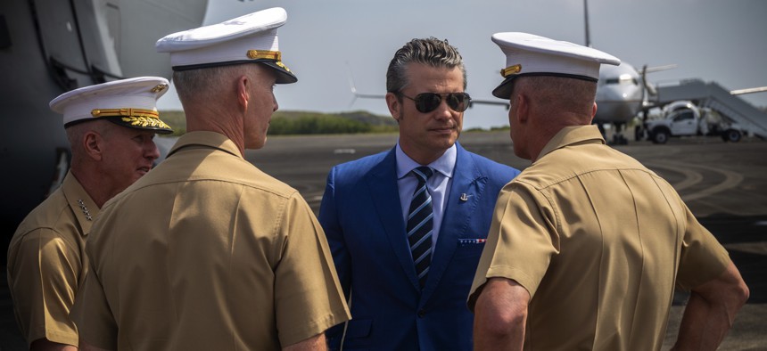 U.S. Defense Secretary Pete Hegseth speaks with three Marine Corps generals at Iwo To, Japan, on March 29, 2025.