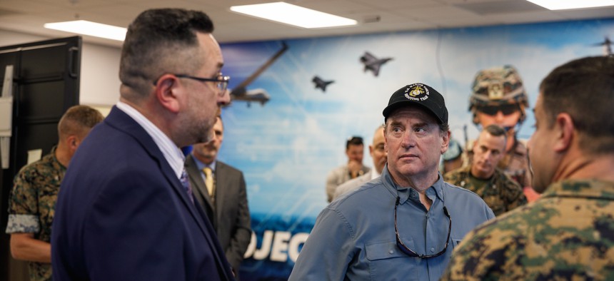 Hector Viramontes of Marine Corps Training and Education Command, left, speaks to John Phelan, the 79th secretary of the Navy, during a visit to the TECOM Integration Center in Stafford, Virginia, June 25, 2025.