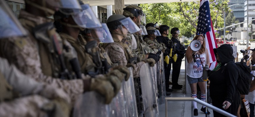Demonstrators gather in front of the federal building guarded by a mix of U.S. Marines and National Guard troops during the "No Kings" protest following federal immigration operations, in Los Angeles, on July 4, 2025.