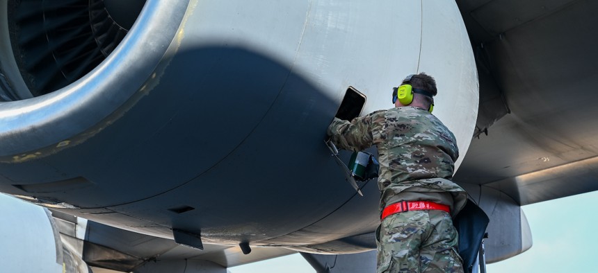 Staff Sgt. Patrick Garrett, 512th Maintenance Squadron, adds jet engine oil into a C-17 Globemaster III aircraft on Yokota Air Base, Japan, March 17, 2025.