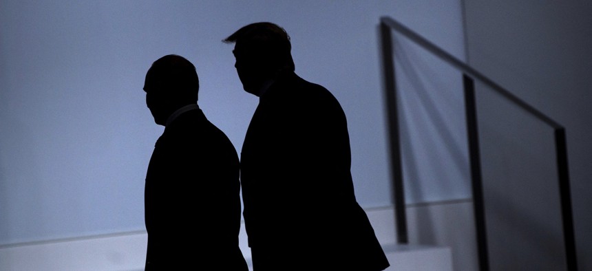 Russia's President Vladimir Putin, left, and US President Donald Trump arrive for a group photo at the G20 Summit in Osaka on June 28, 2019.