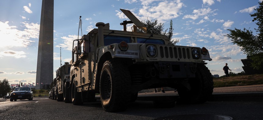 Military vehicles of the DC National Guard are parked near the Washington Monument on August 12, 2025, in Washington, D.C.