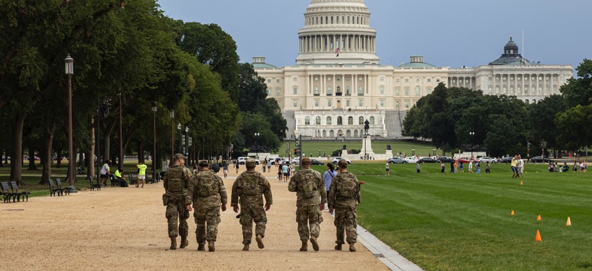 National Guardmen walk on the National Mall on August 14, 2025, in Washington, D.C., after President Donald Trump's deployment of federal forces and takeover of the city's police department.