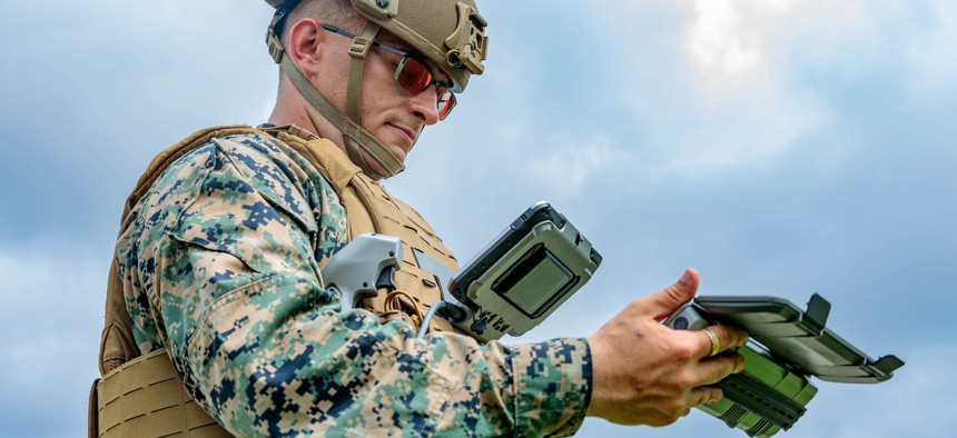 Cpl. Hunter Zenoni, an unmanned aerial systems pilot and mechanic with the Marine Corps Drone Attack Team, pilots a small unmanned aircraft system during a drone demonstration at the Pentagon, July 10, 2025.