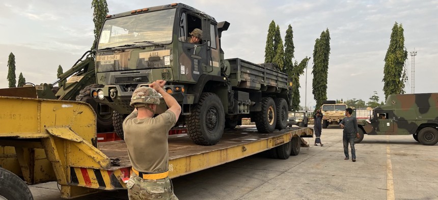 Soldiers from 98th Support Maintenance Company, 17th Combat Sustainment Support Battalion, 11th Airborne Division, ground guide a tactical vehicle onto a flatbed trailer during an exercise in Indonesia, August 14, 2025.