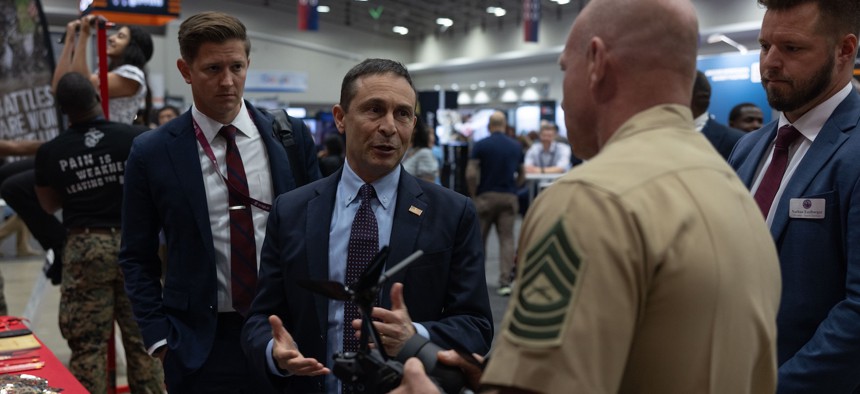 Defense Innovation Unit Director Doug Beck speaks to Master Sgt. Joshua Shelly about the Neros Archer drone during the AI+ Expo in Washington D.C., June 2, 2025. 