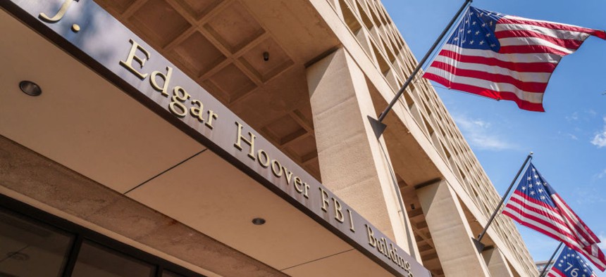 Historical versions of the U.S. flag fly over the entrance to the Federal Bureau of Investigation (FBI) headquarters building on September 15, 2024, in Washington, D.C.