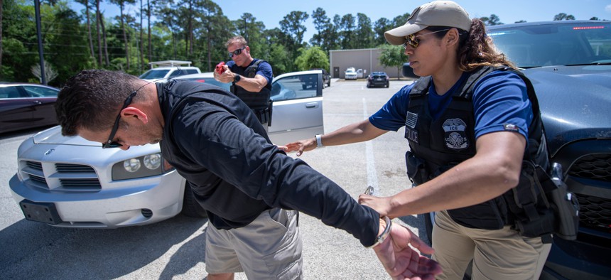 ICE Enforcement and Removal Operations deportation officers conduct the simulated arrest of a suspect during vehicle-stop training at the Federal Law Enforcement Training Center in Glencoe Georgia on April 13, 2022.