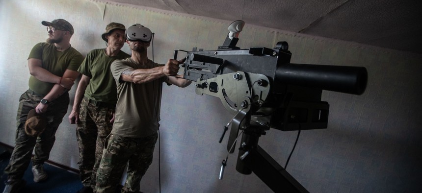 A Ukrainian soldier uses a virtual reality anti-aircraft gun to practice shooting at Russian drones in Kharkiv, Ukraine, on July 26, 2025.