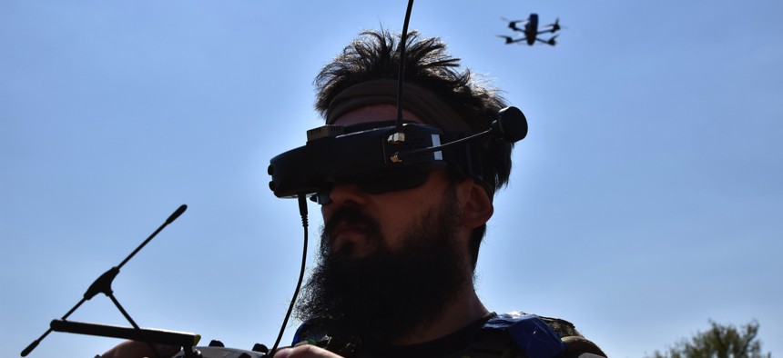 A drone operator of the 15th Brigade (Kara-Dag) of the National Guard of Ukraine seen with a FPV (first-person view) kamikaze drone on a wheat field after a military training exercise.