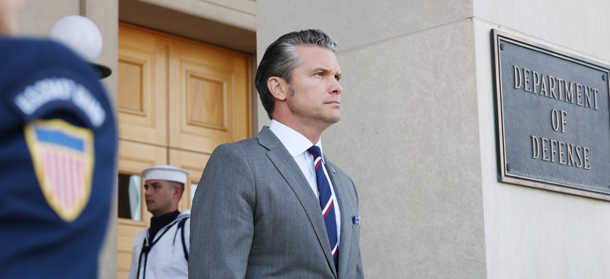 U.S. Defense Secretary Pete Hegseth waits outside the Pentagon on September 22, 2025.